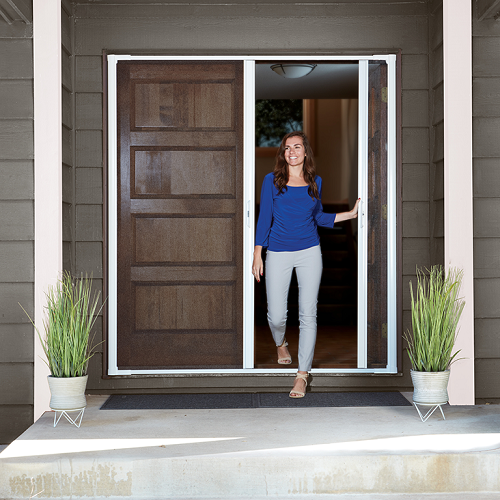 Beautiful woman opening the door of her home