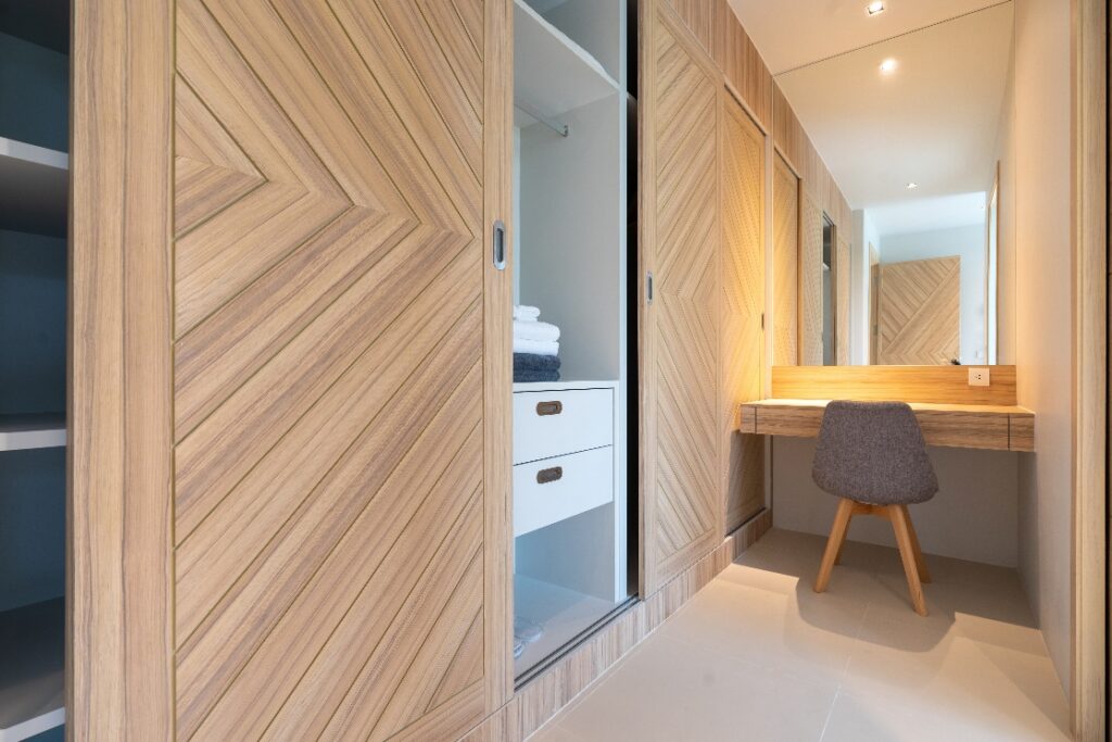 wooden wardrobe with working table and chair in bedroom